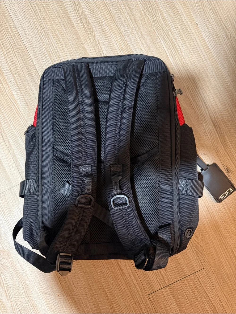 Tumi Red and Black Men/Women’s Backpack with Multiple Front Pockets